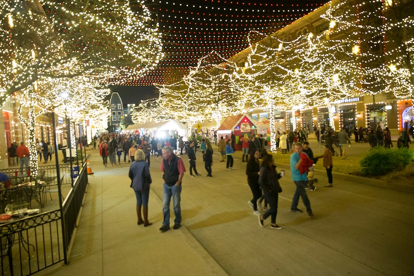 People walked amid the bright lights at Merry Main Street in Frisco on Dec. 1, 2018. The...