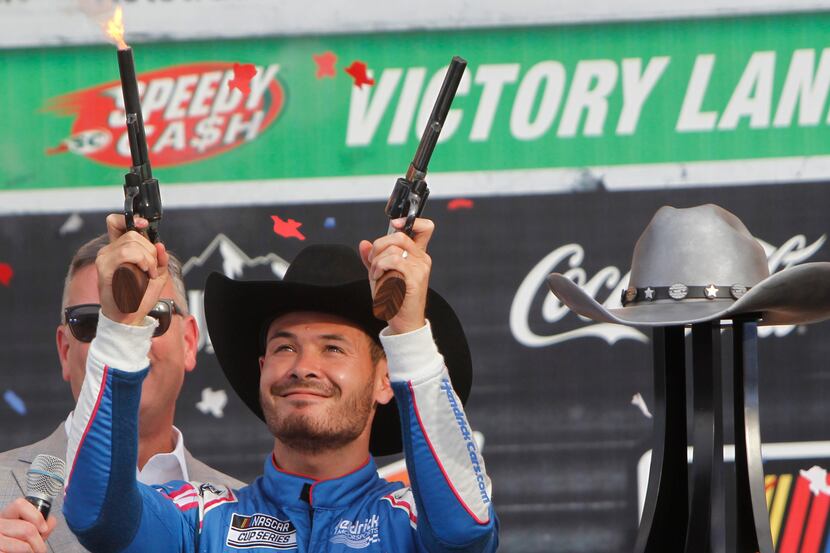 Kyle Larson fires a pair of pistols in Victory Lane as he celebrated his win after driving...