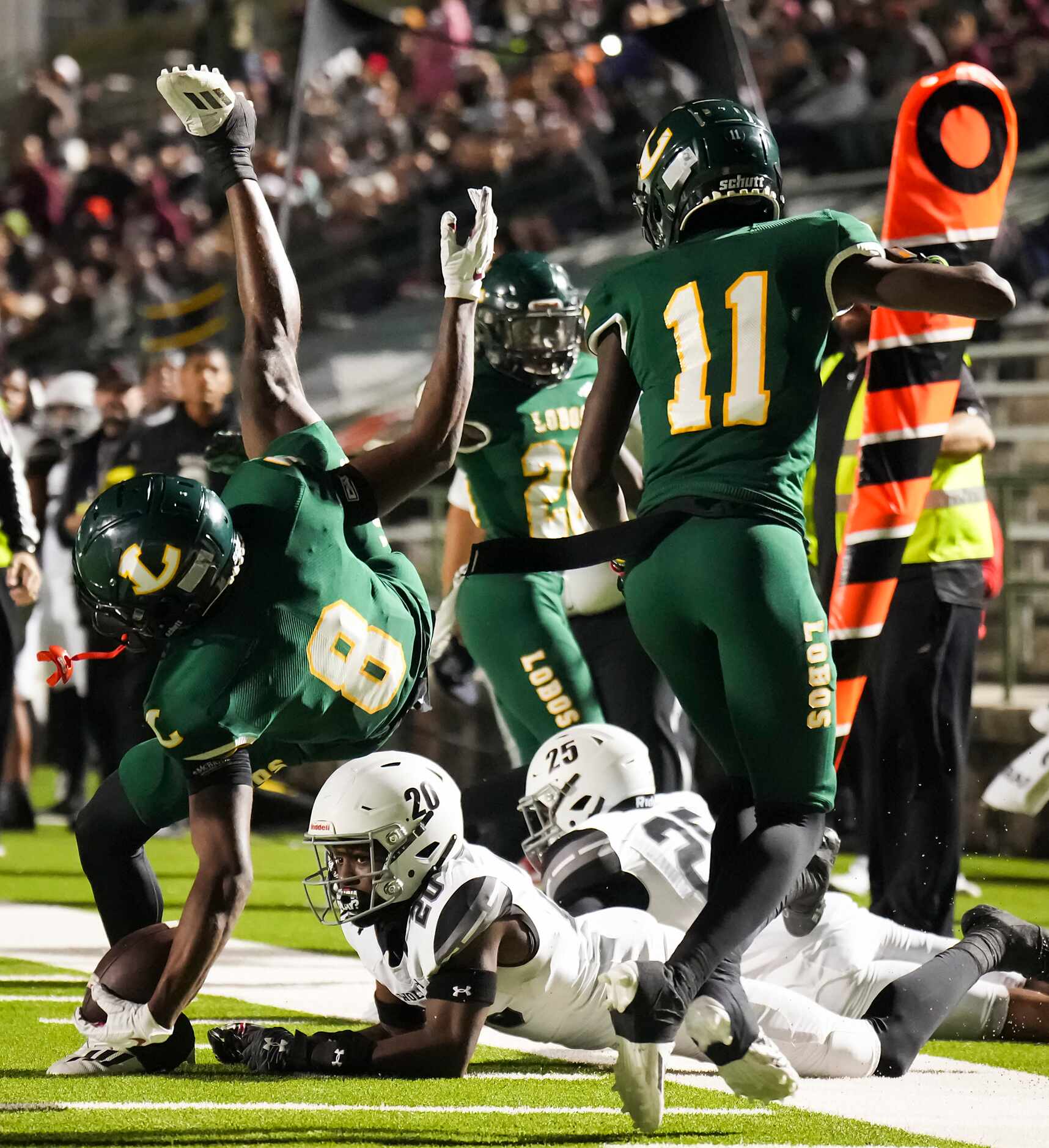 Longview wide receiver Jalen Hele (8) is upended by Mansfield Timberview defensive back...