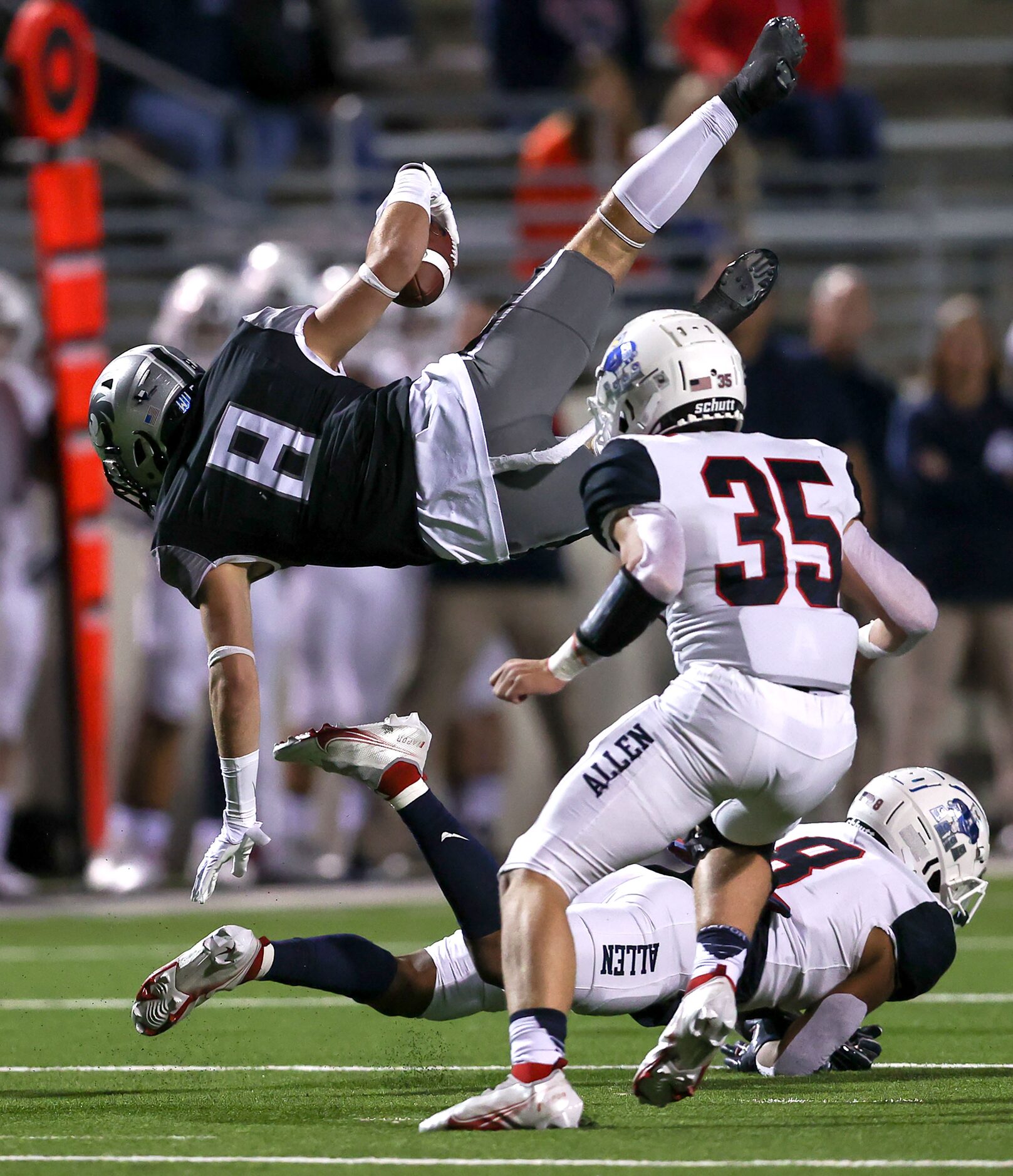 Denton Guyer wide receiver Sutton Lee (8) gets tripped up by Allen defensive back Tru...