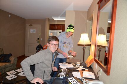 Jon helping prepare athlete bibs for a high school cross country race in 2014.