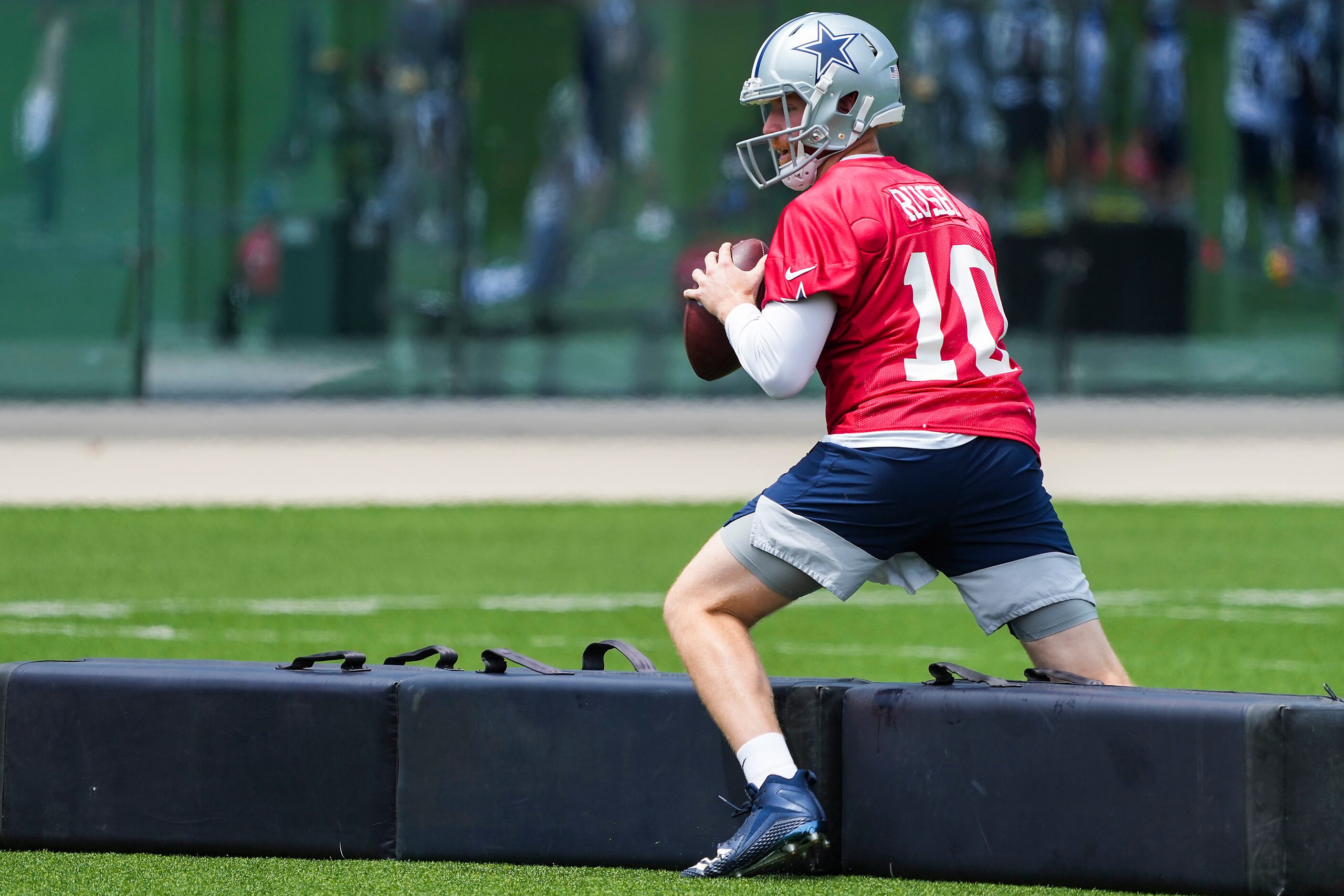 Dallas Cowboys quarterback Cooper Rush runs a drill during a minicamp practice at The Star...