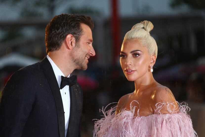 Actress and singer Lady Gaga and actor Bradley Cooper pose for photographers upon arrival at...