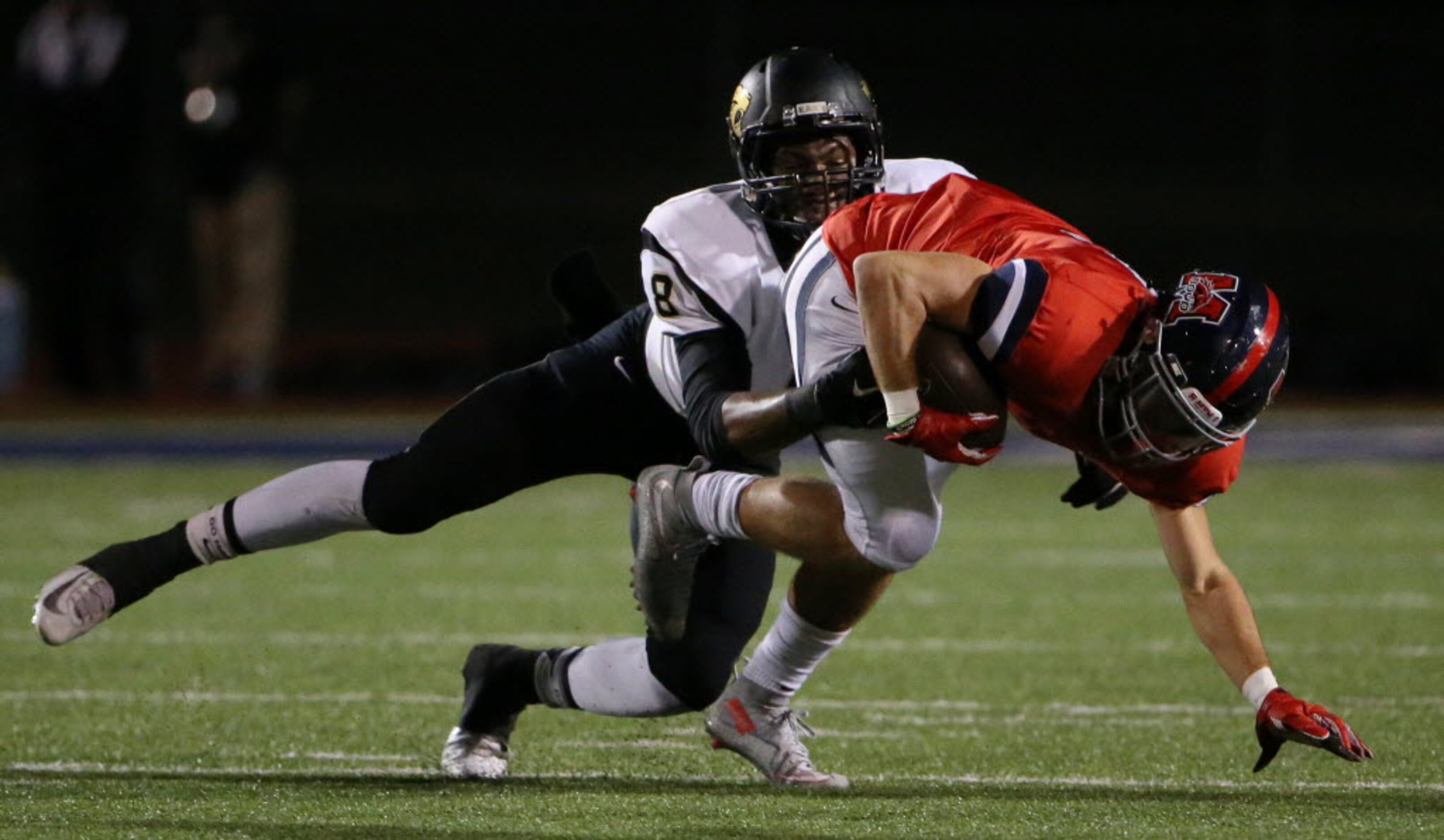 Plano East defensive back Reuben donald (8) tackles McKinney Boyd wide receiver Brandon...