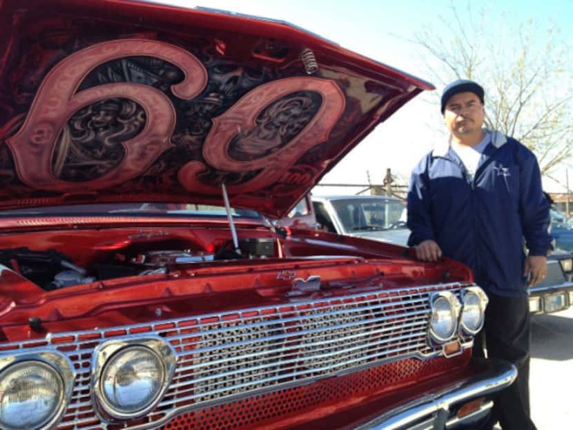 Joe Ruiz posed proudly next to his cherry red 1987 Chevy truck, which is dressed up with...