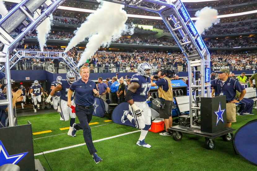 Dallas Cowboys head coach Jason Garrett takes the field with his team to play against the...