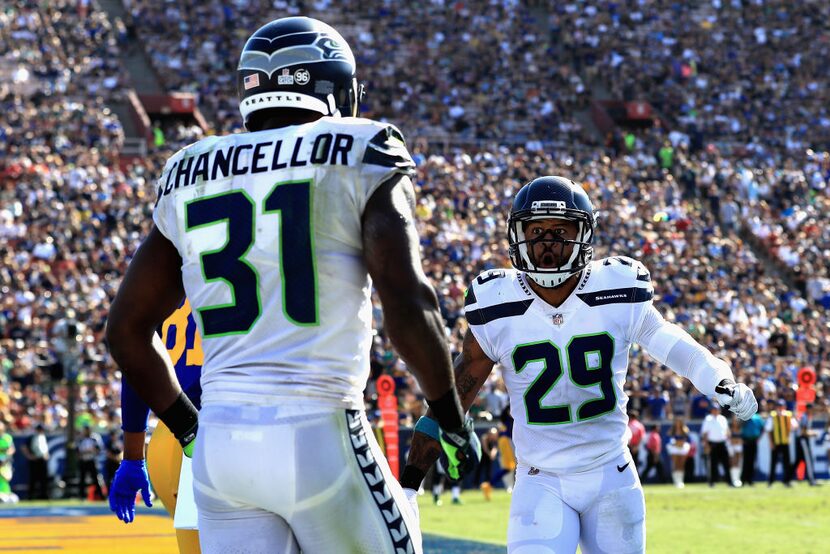 LOS ANGELES, CA - OCTOBER 08:   Kam Chancellor #31 celebrates a broken pass play with  Earl...