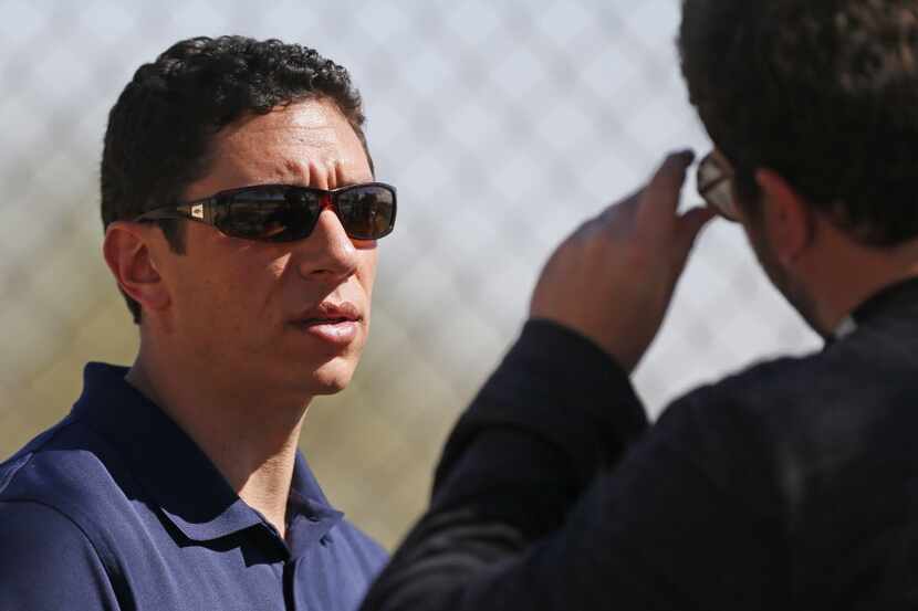Texas general manager Jon Daniels watches the intrasquad game during Texas Rangers baseball...