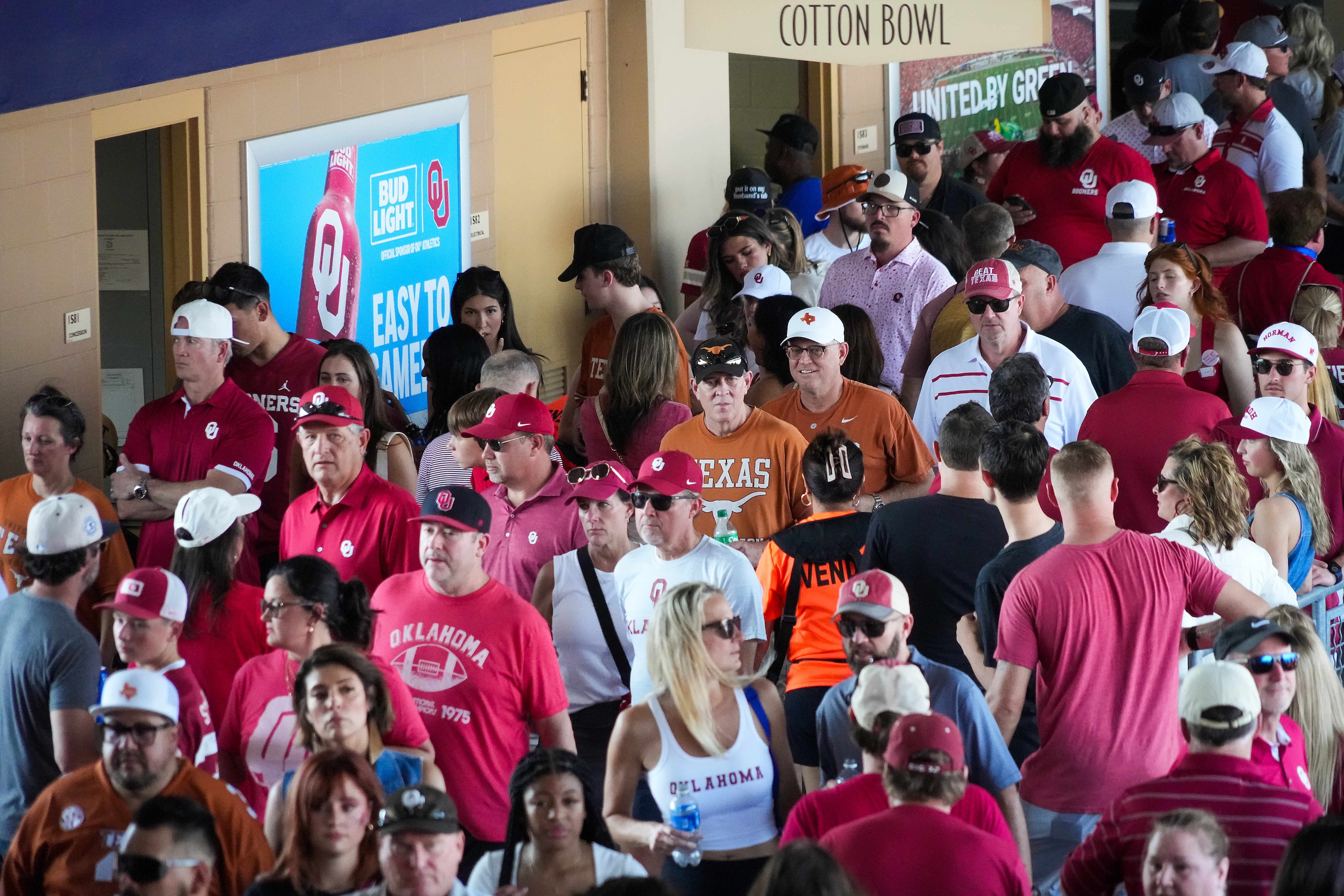 Fans walk the crowded concourse before an NCAA college football game between Texas and...