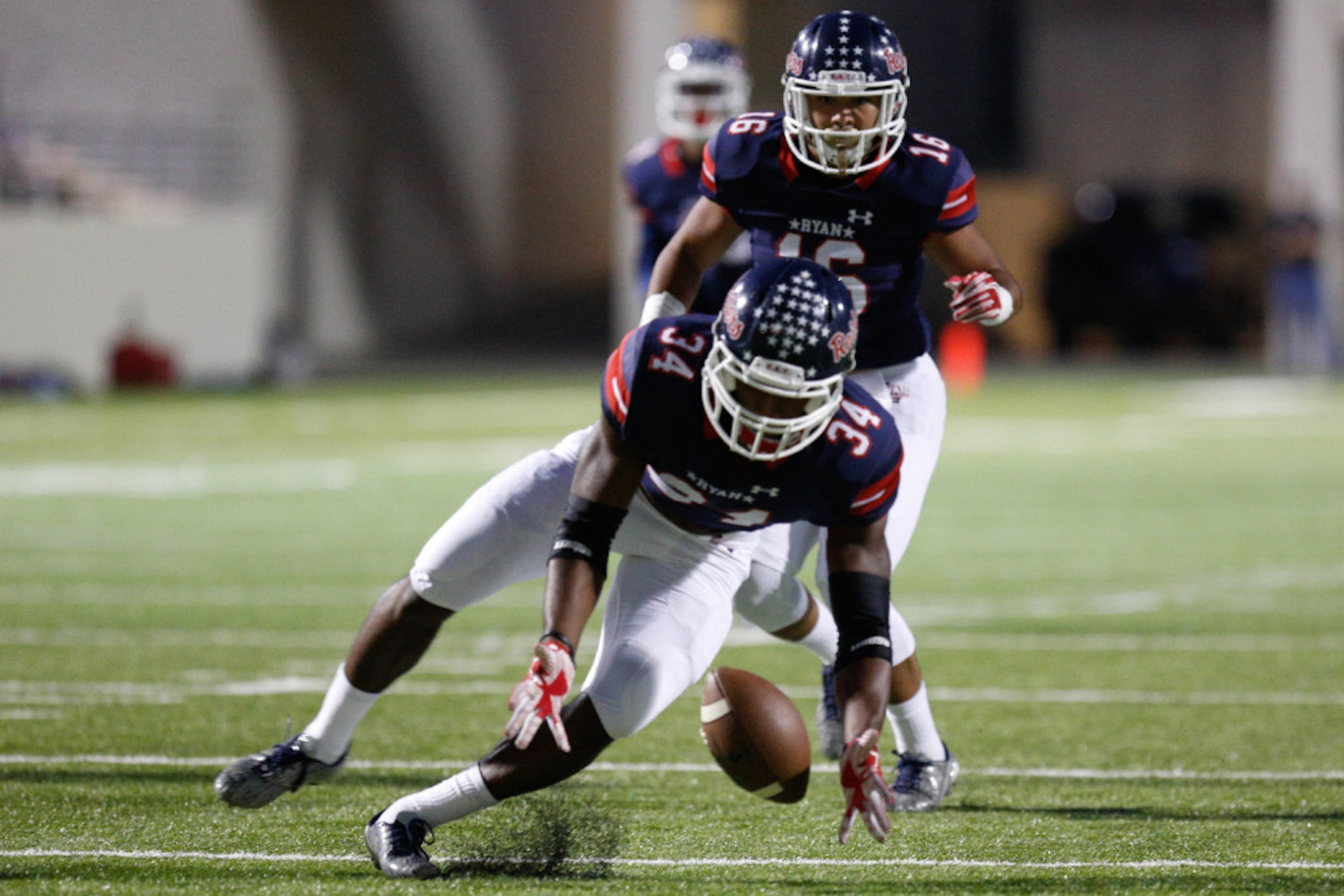 Ryan senior defensive end Thomas Wilson III (34) picks up the football after the Sherman...