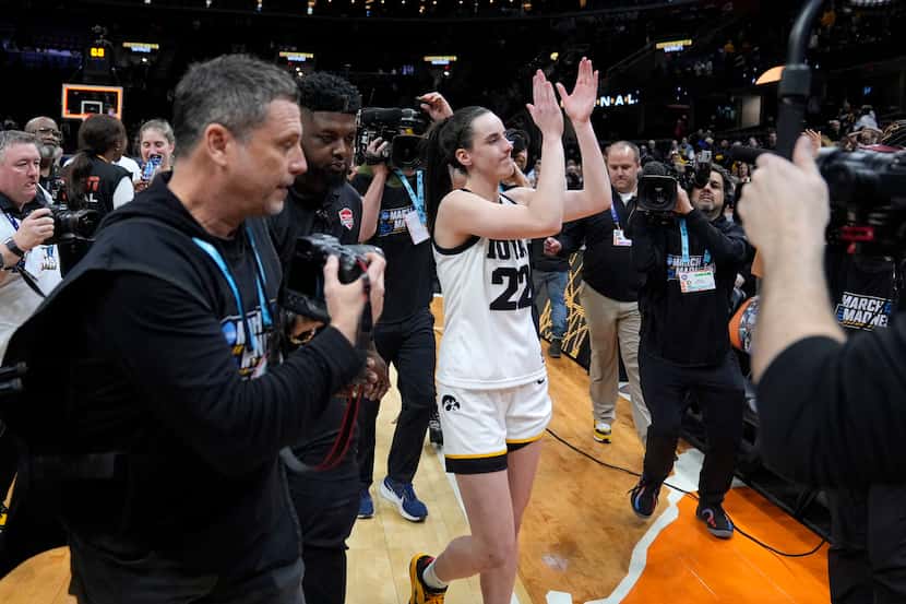 Iowa guard Caitlin Clark (22) walks off the court after a Final Four college basketball game...