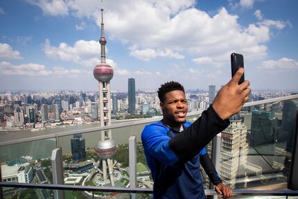 Dallas Mavericks guard Dennis Smith Jr. takes a selfie in front the Oriental Pearl Tower and...