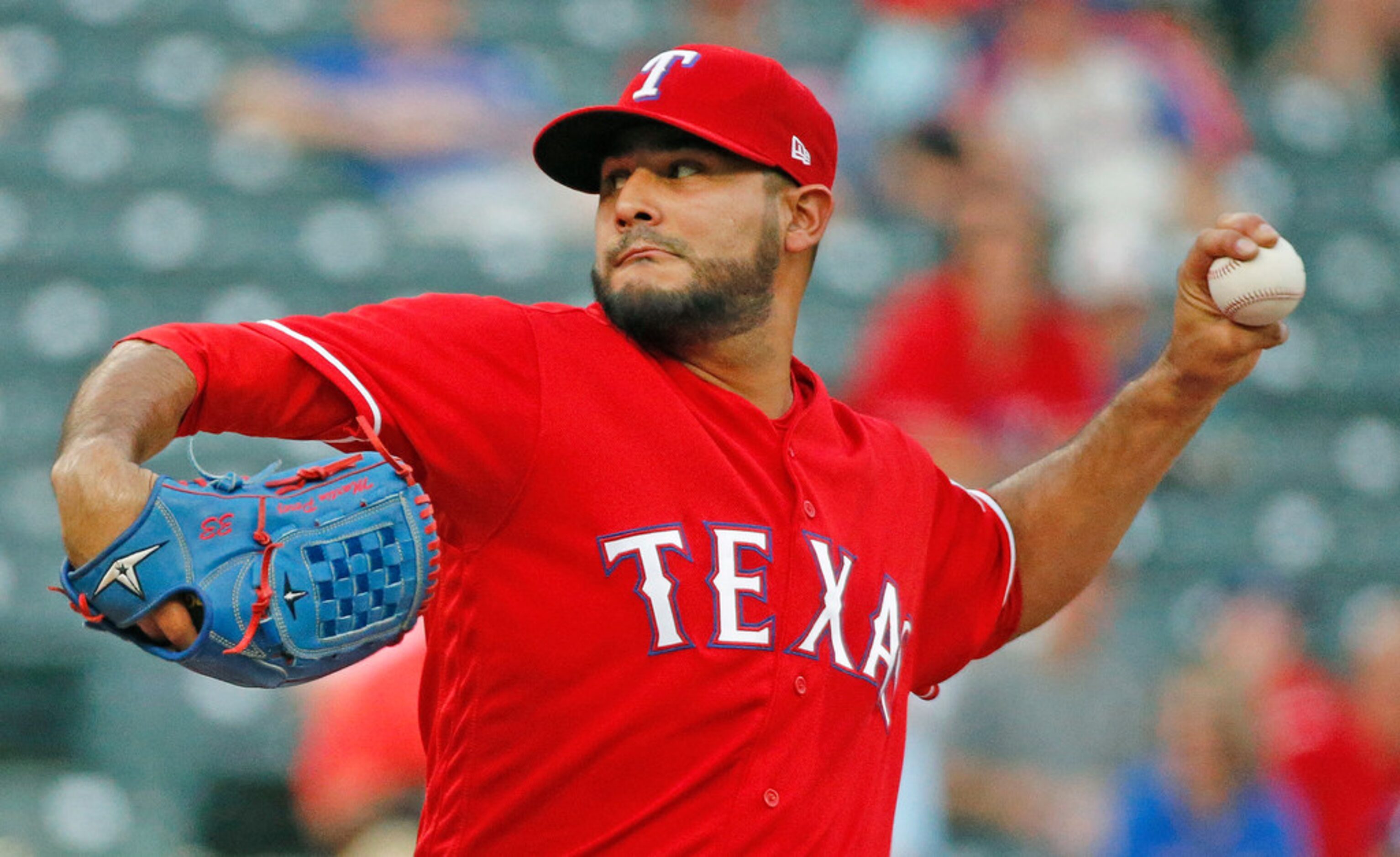 Texas Rangers starting pitcher Martin Perez (33) throws a forst-inning pitch during the...