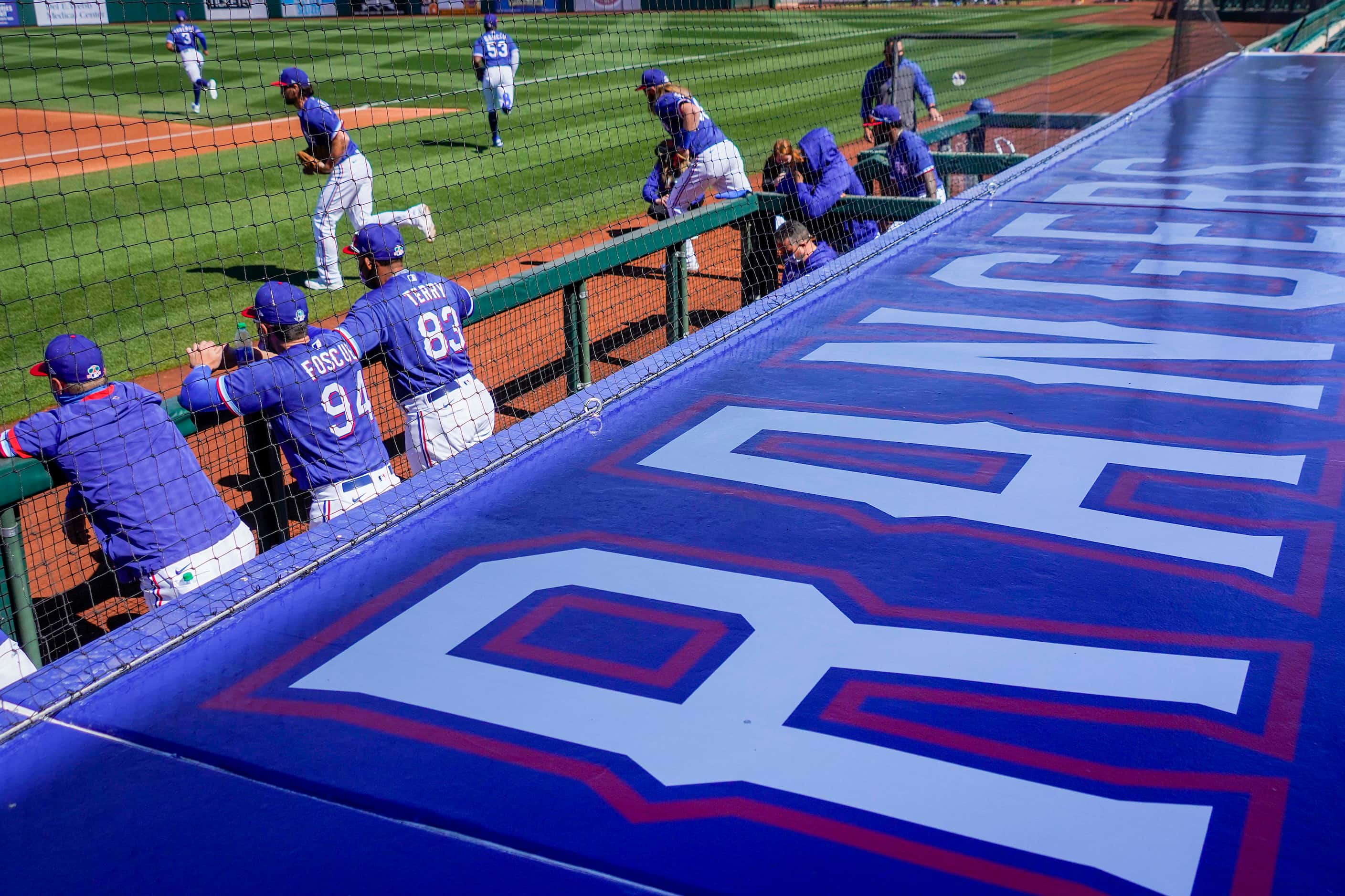 Texas Rangers players take the field to face the San Francisco Giants in a spring training...