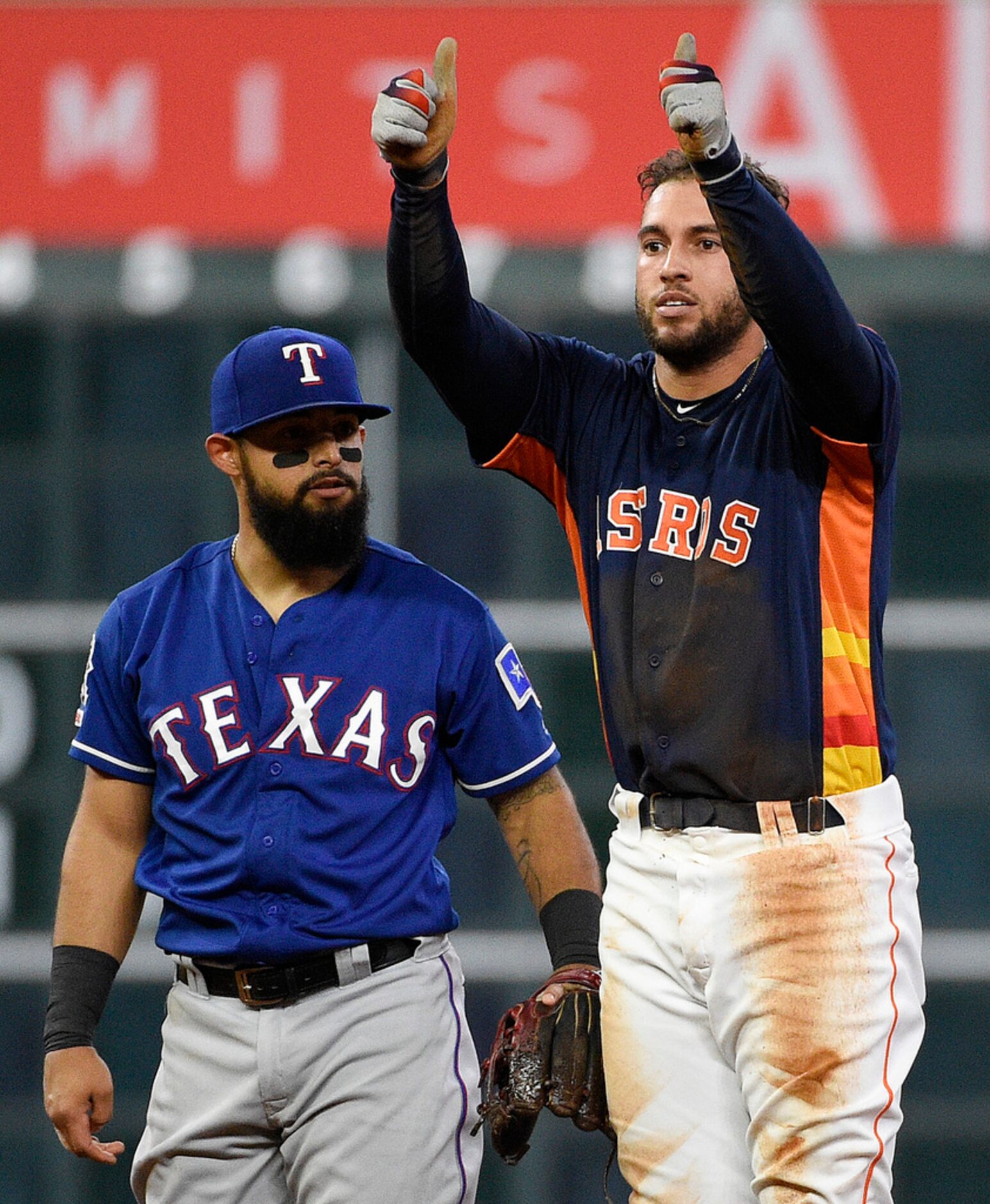 Houston Astros' George Springer, right, gestures after hitting a double, next to Texas...