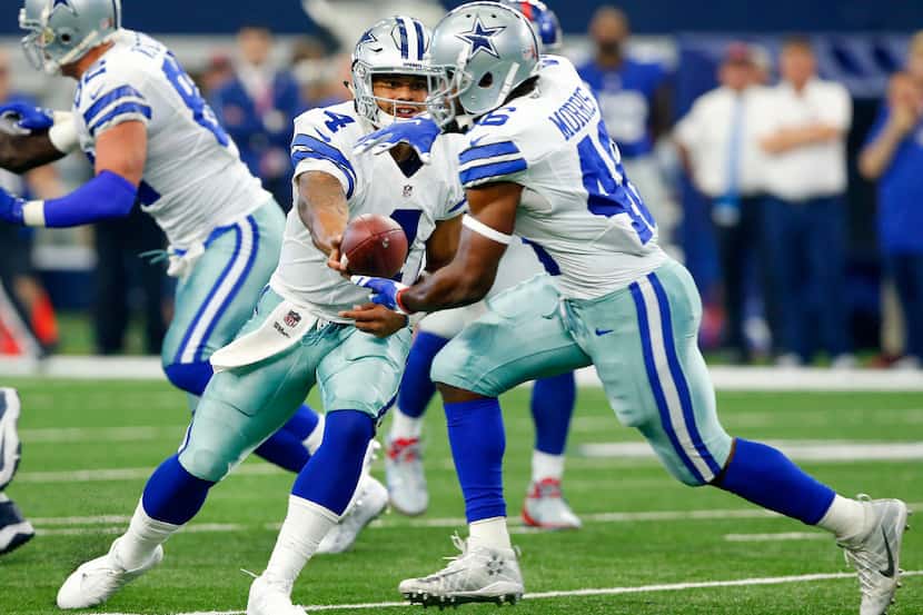 Dallas Cowboys quarterback Dak Prescott (4) hands the ball off to running back Alfred Morris...