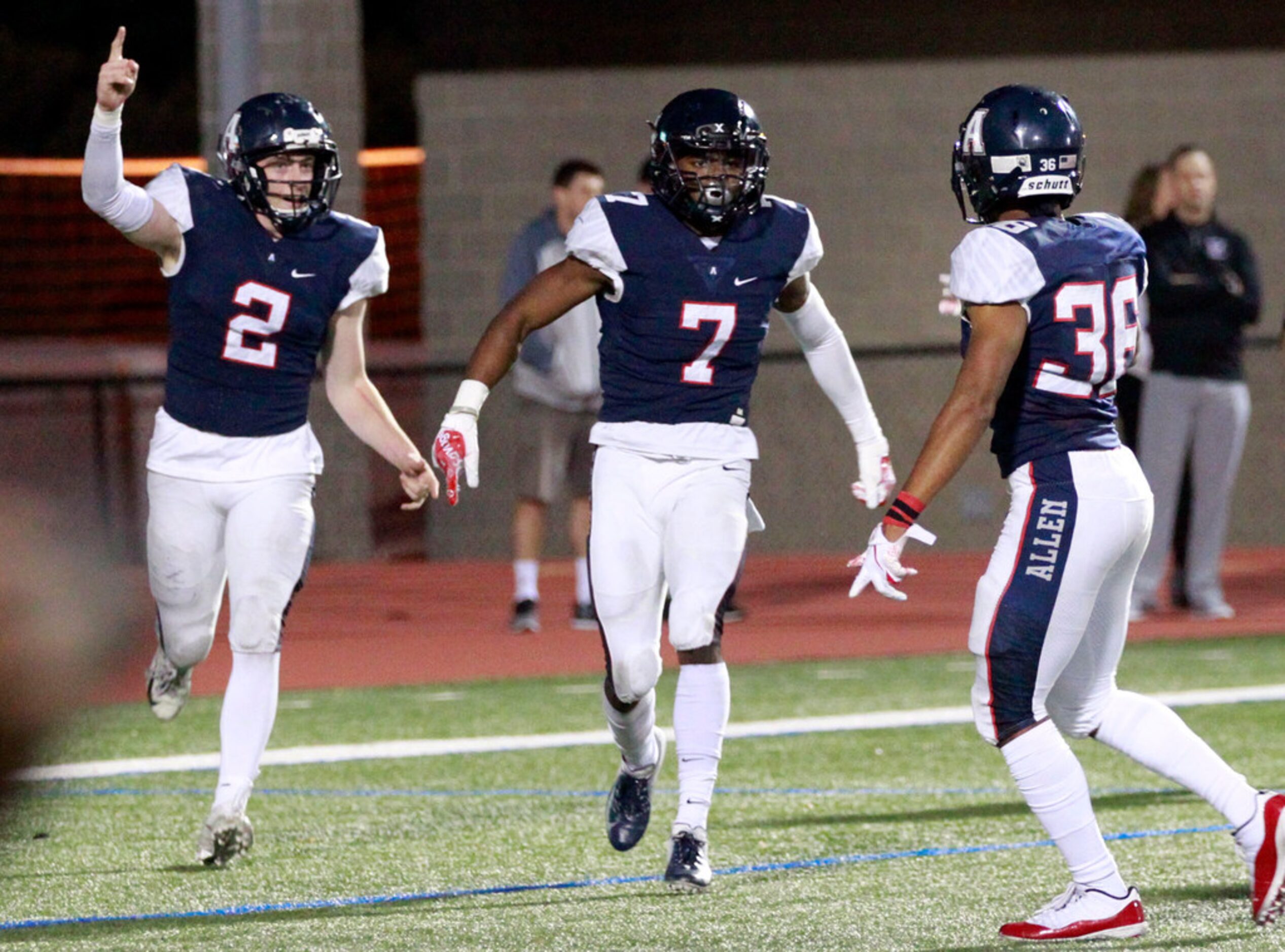 Allen defenders Jaden Healy (2), Devyn Butler (7) and Will Drogosch (38) celebrate Butler's...