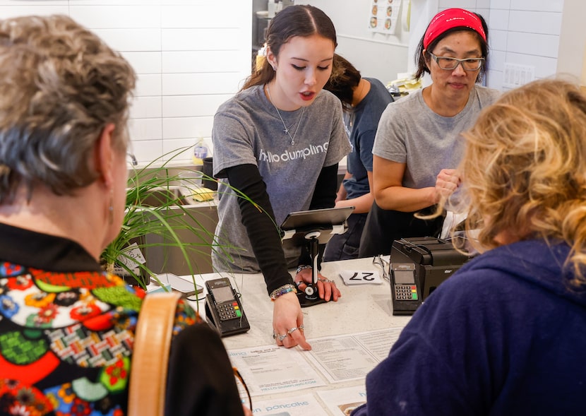 Olivia Chow-Gillette (center) helps customers with their orders alongside her mother and...