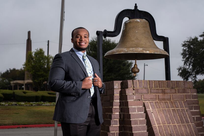 Sophomore Kenneth Wayne Boston stands alongside the Heritage Bell at Paul Quinn College. The...