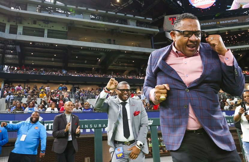 Roland Parrish (center) claps as his son, Ro Parrish, and Mitchell Ward (right) dance...