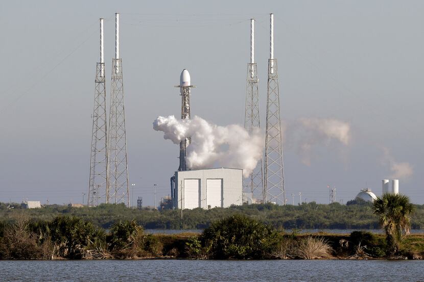 A Falcon 9 SpaceX rocket, stands ready at space launch complex 40, shortly before the launch...