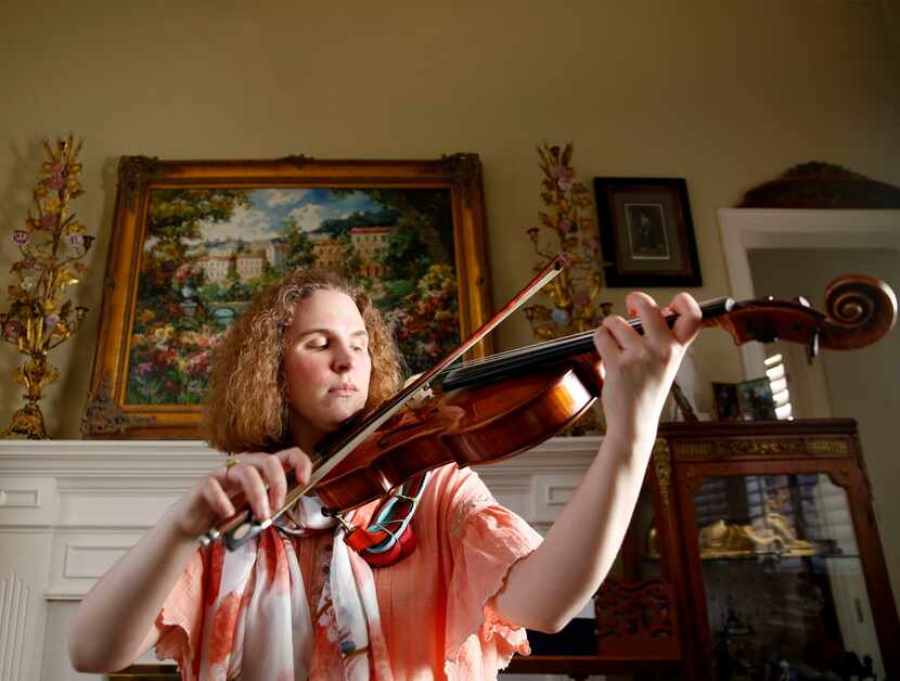 Rebecca Glass plays her viola in her home in Plano.