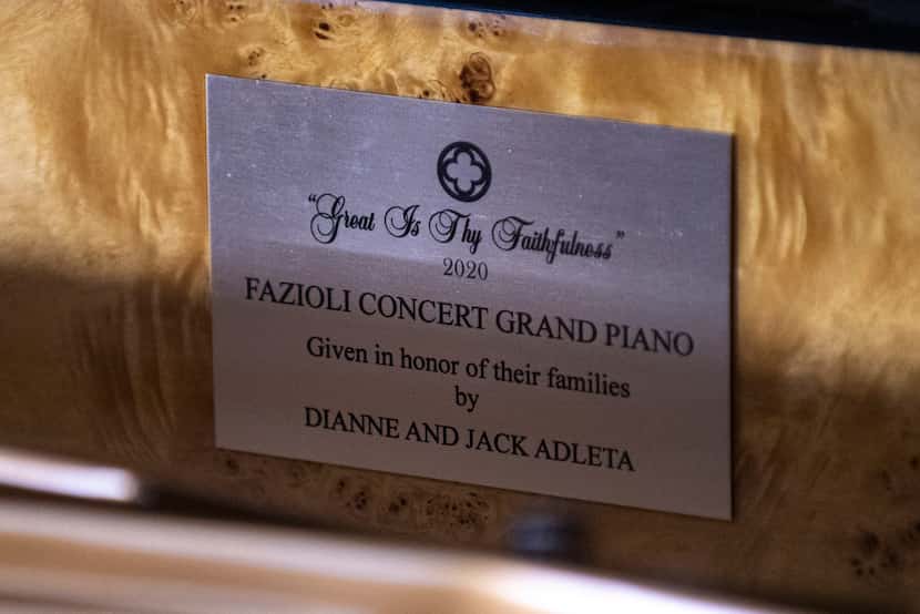 A plaque inside the Fazioli grand piano at Highland Park UMC honors the Adletas' donation.