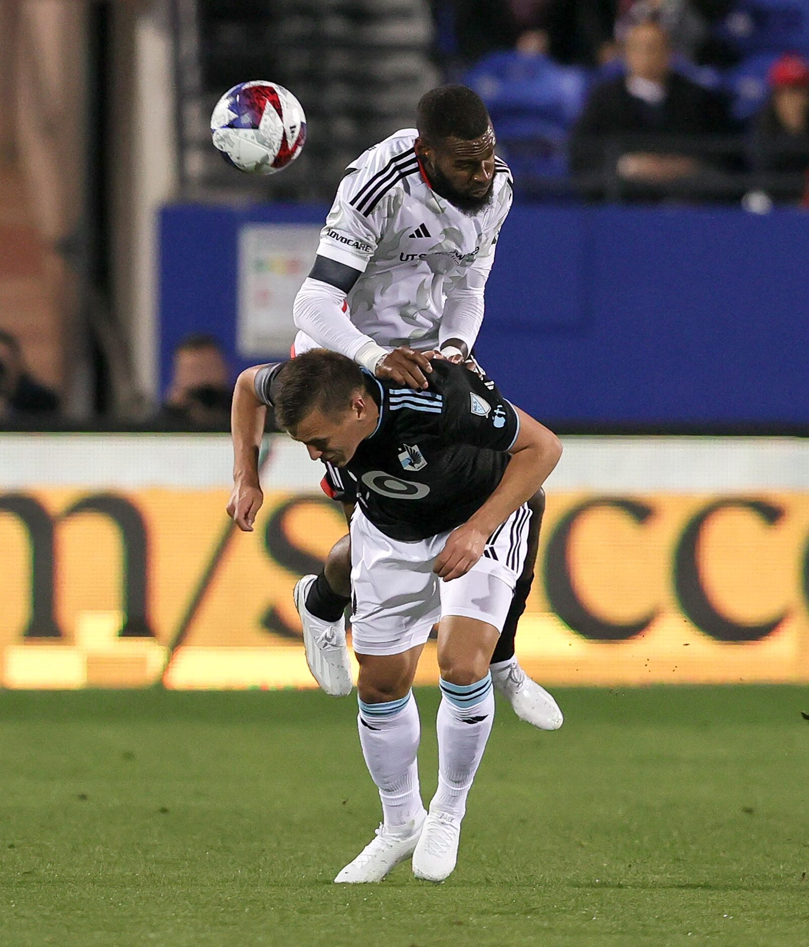 FC Dallas defender Sebastien Ibeagha tries to go over the top of Minnesota United Robin Lod...