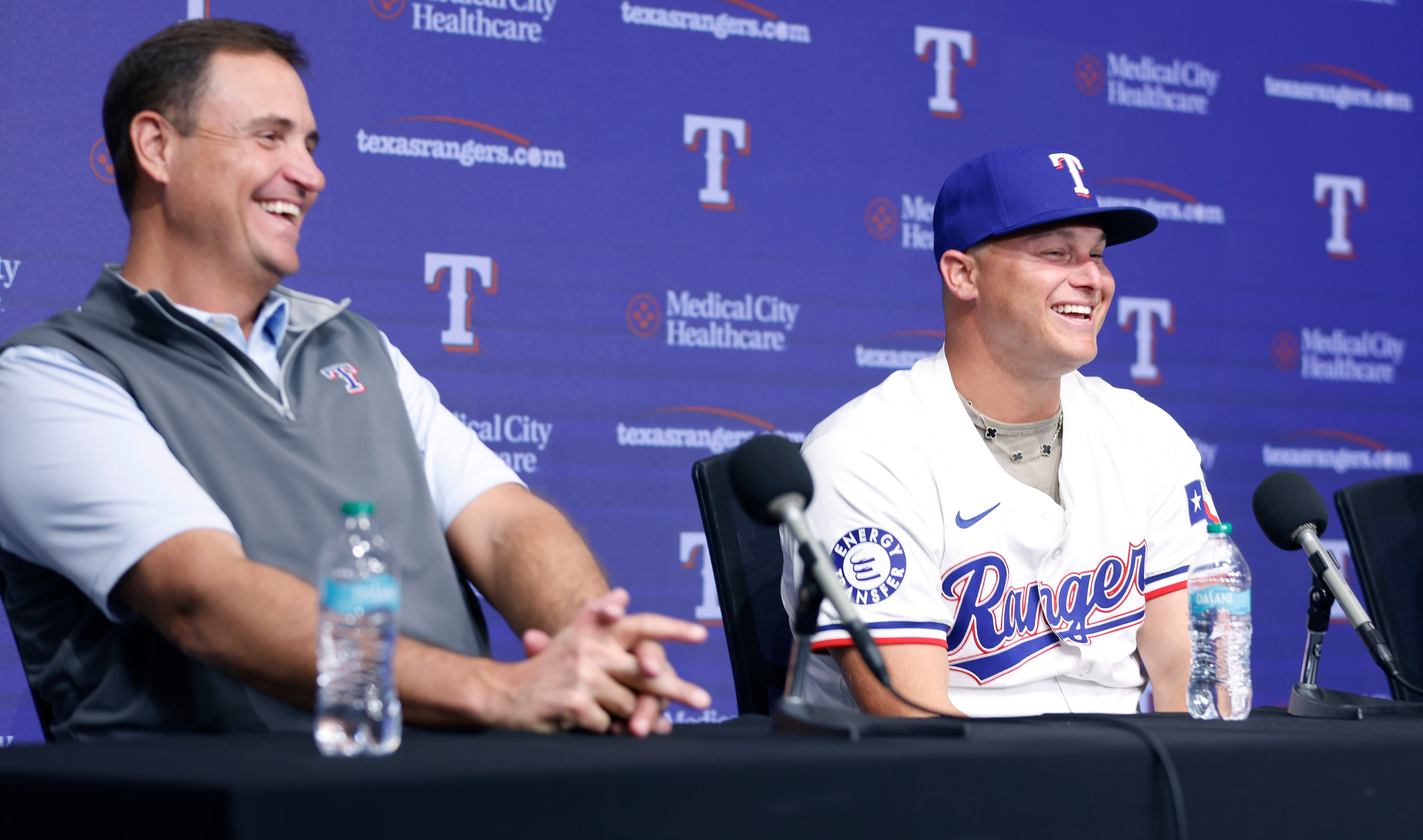 Rangers President of Baseball Operations Chris Young (left) laughs with outfielder Joc...