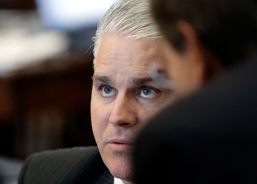 Rep. Dan Huberty, R-Houston, talks with fellow lawmakers on the House floor.