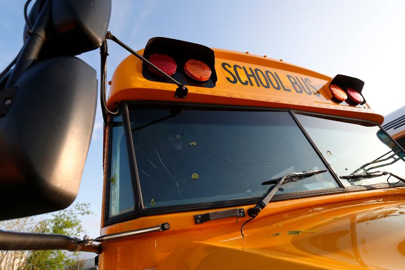 A windshield of a school bus is damaged by last night's hailstorm at the Little Elm ISD...