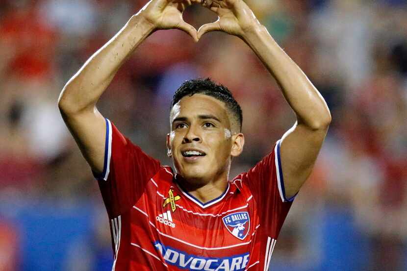 FC Dallas midfielder Victor Ulloa (8) flashes a heart shape with his hands to fans after...