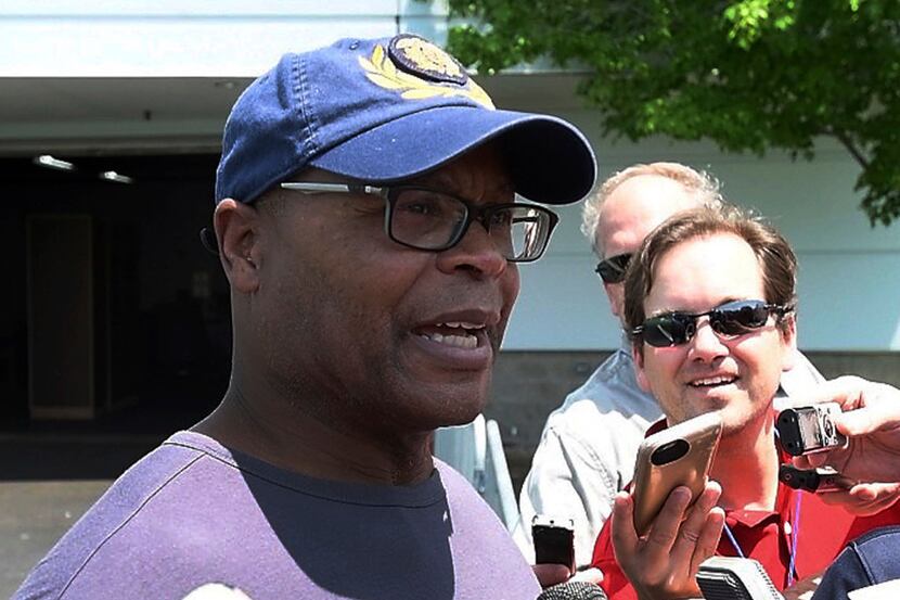 Mike Singletary, former NFL football player and coach, talks to reporters with visiting the...