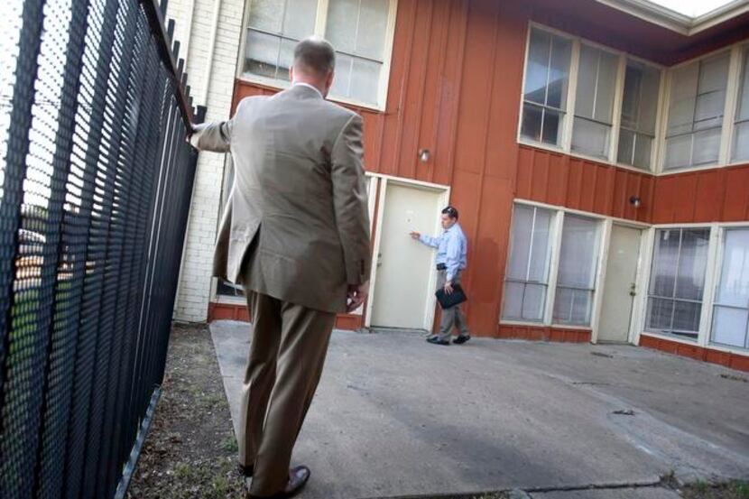 
Dallas Police detectives Tim Casey  (left) and Will Vick visit an apartment to check on...