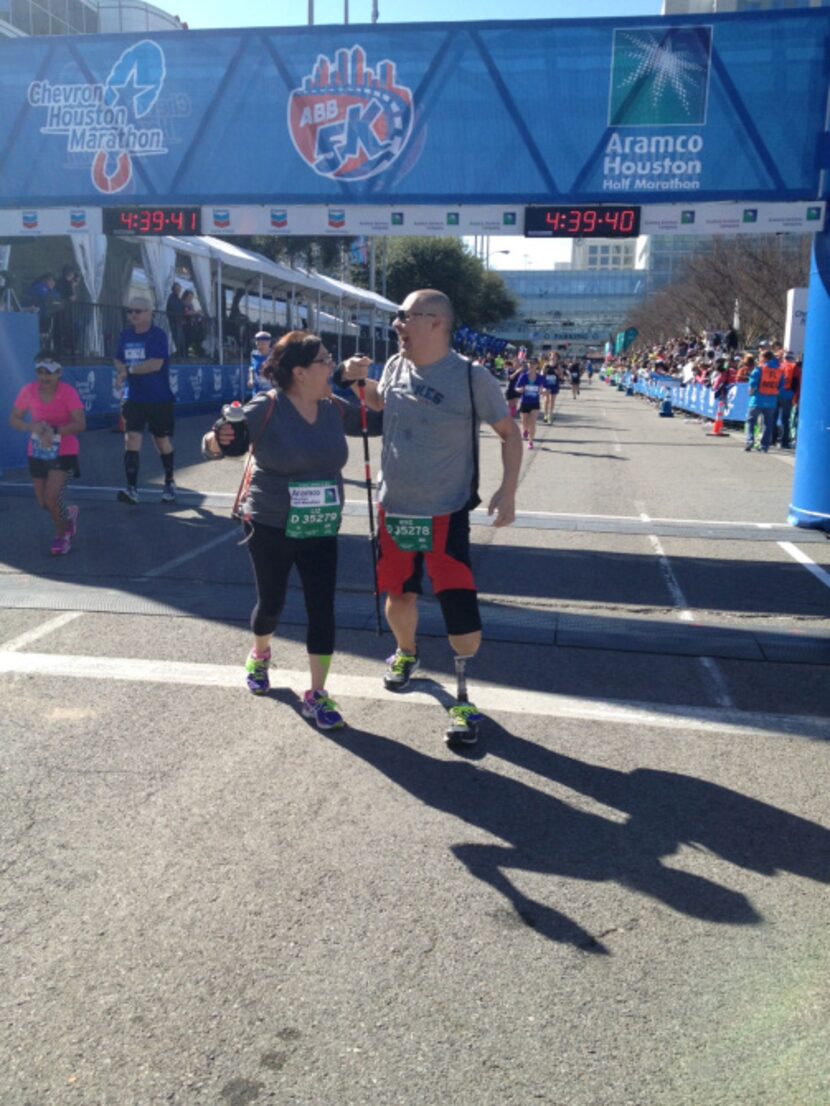 Liz and Mike celebrate at the finish line of the Chevron Houston Marathon/Aramco Houston...