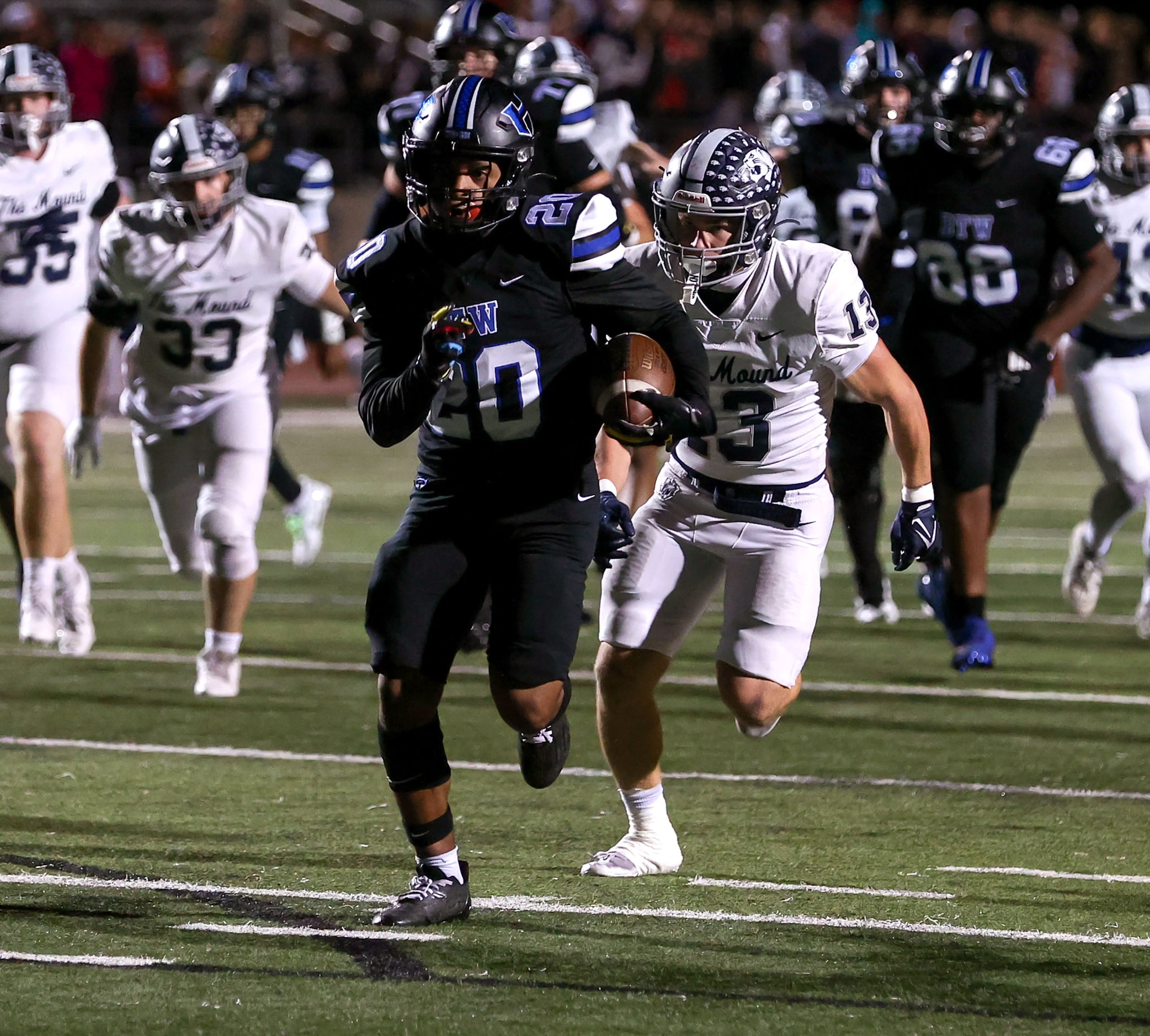 Hebron running back Ahmad Ware (20) sprints past Flower Mound safety Silas Wilson (13) for a...