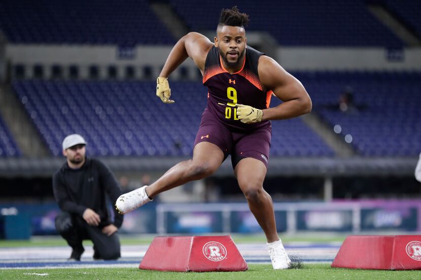 Texas A&M defensive lineman Kingsley Keke runs a drill at the NFL football scouting combine...