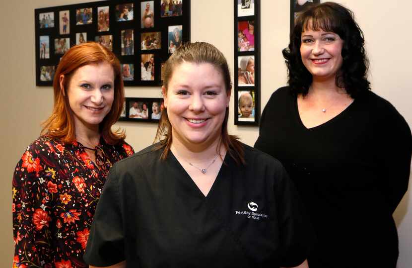 Ashley Moore (center), of Rockwall, (center), a surrogate who is currently pregnant for a...