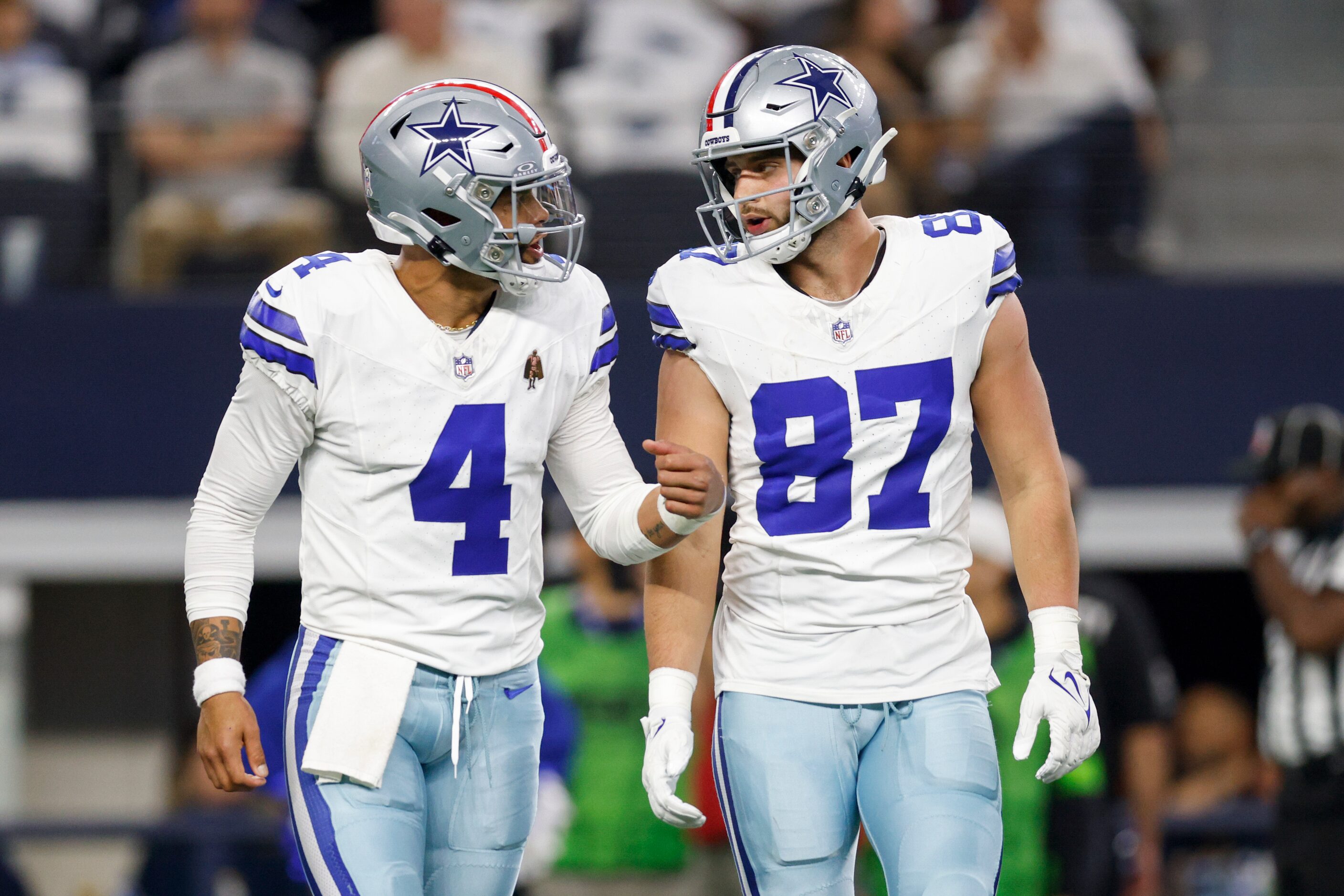 Dallas Cowboys quarterback Dak Prescott (4) talks with tight end Jake Ferguson (87) after an...