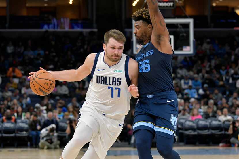 Dallas Mavericks guard Luka Doncic (77) handles the ball against Memphis Grizzlies guard...