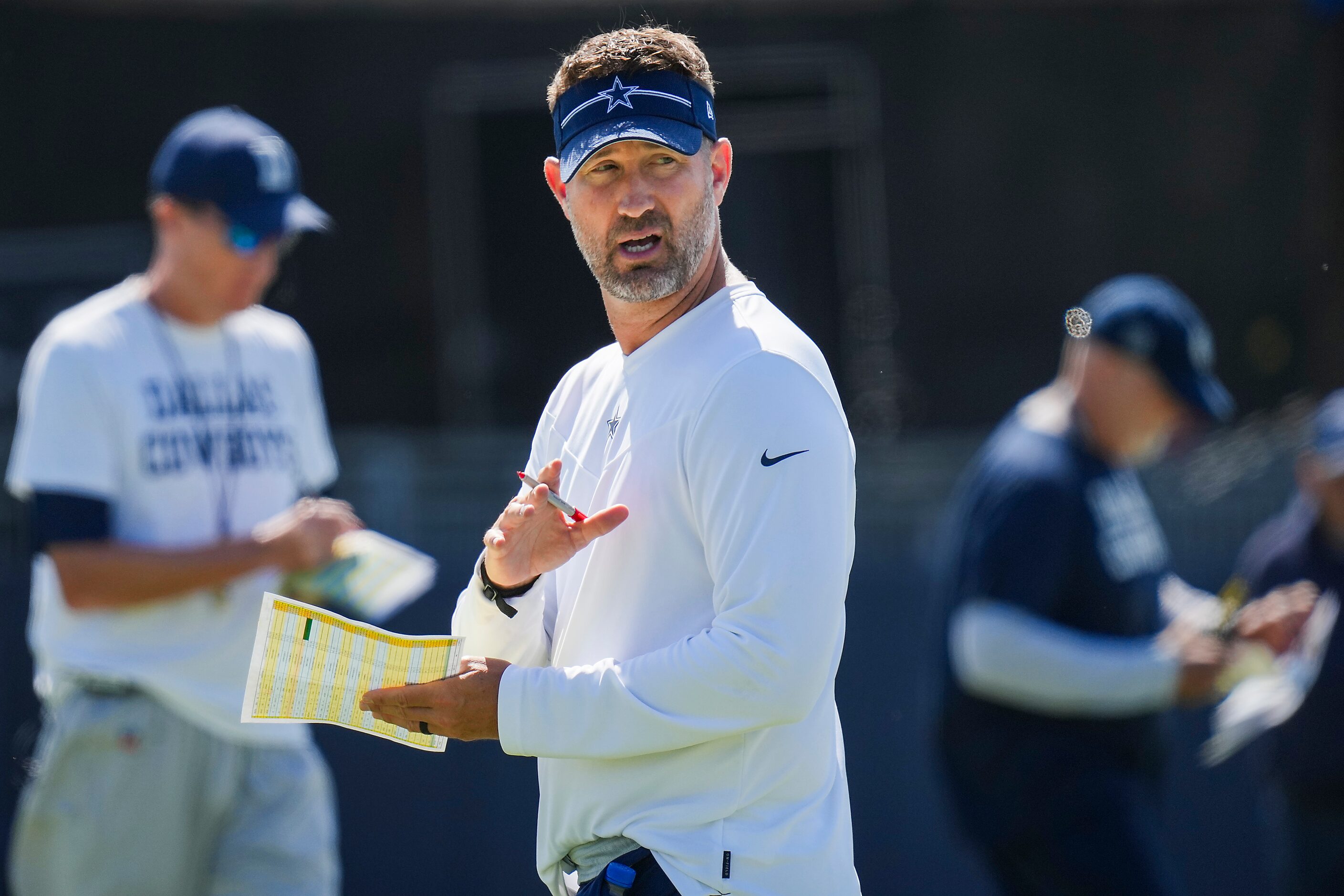 Dallas Cowboys offensive coordinator Brian Shottenheimer motions to players during a...