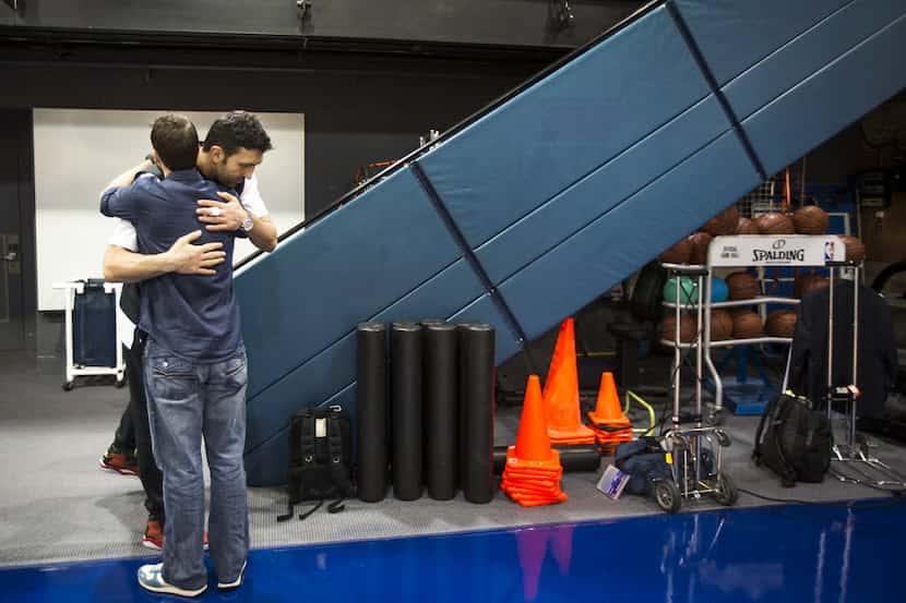 Dallas Mavericks center Zaza Pachulia hugs a media relations staffer as he departs after...