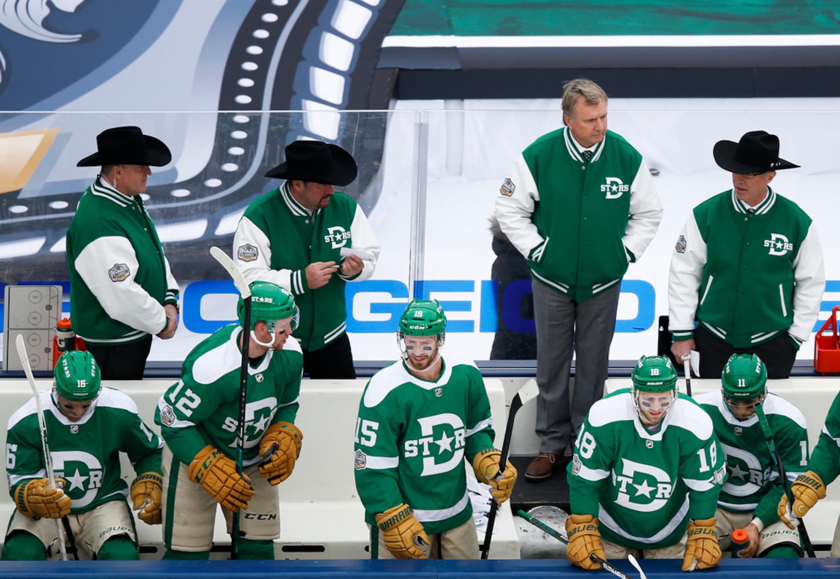 Dallas Stars interim head coach Rick Bowness, second from top right, works the bench during...