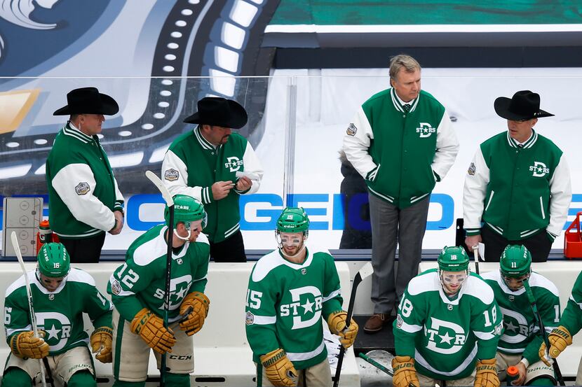 Dallas Stars interim head coach Rick Bowness, second from top right, works the bench during...