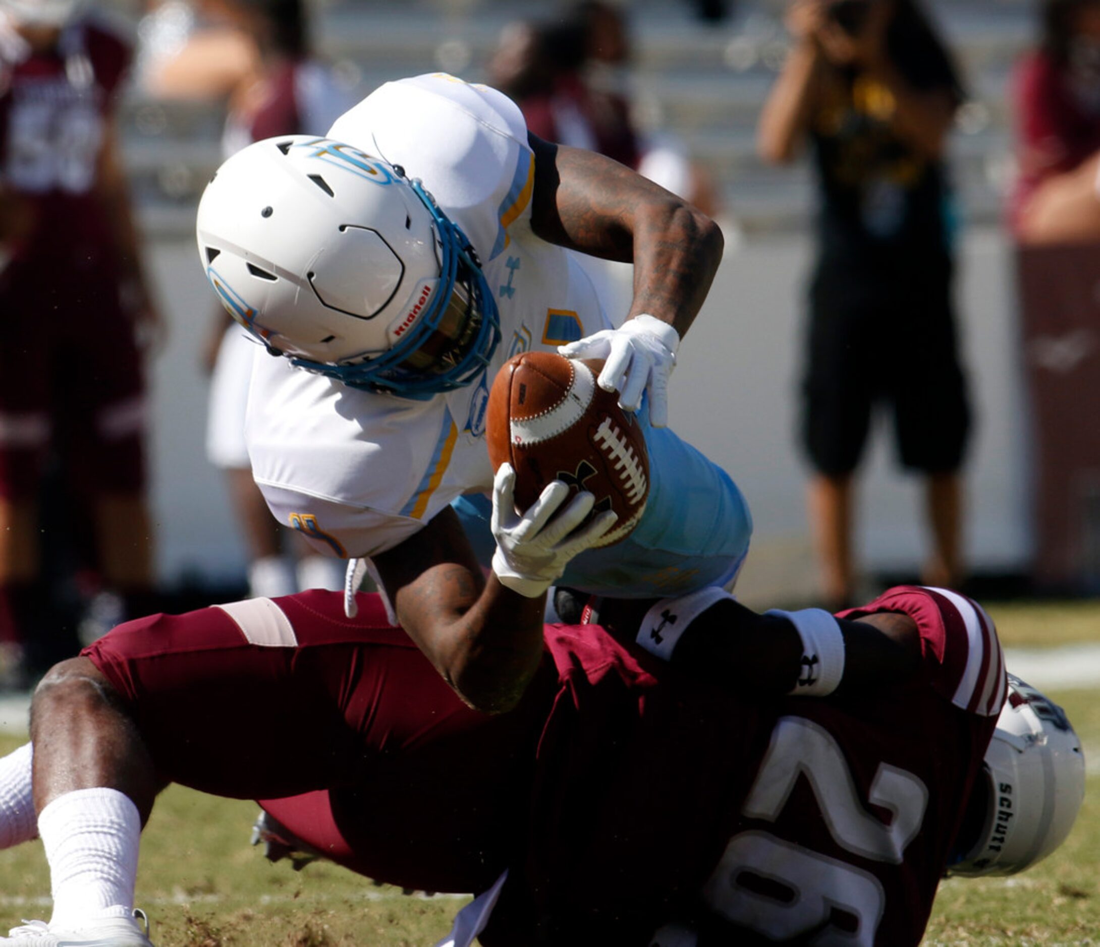 Southern receiver Hunter Register (4) leans for extra yardage as he is tackled by Texas...