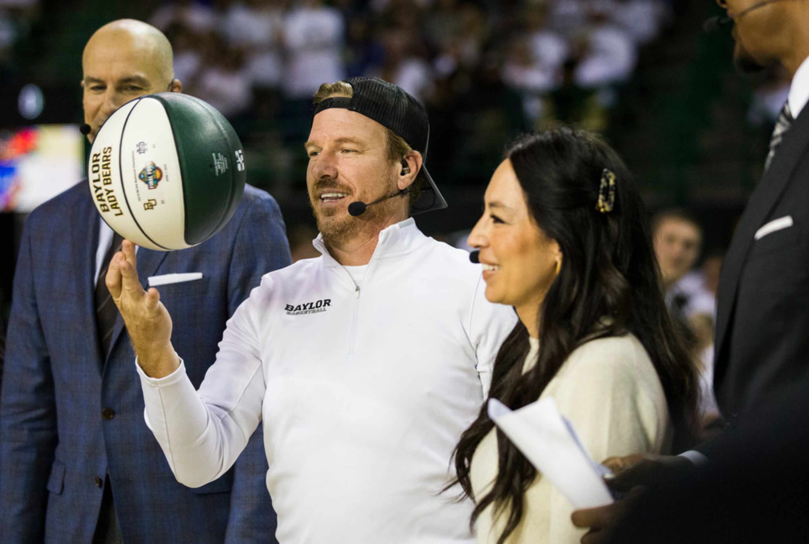 Fixer Upper's Chip Gaines spins a basketball on his finger next to Joanne Gaines before an...