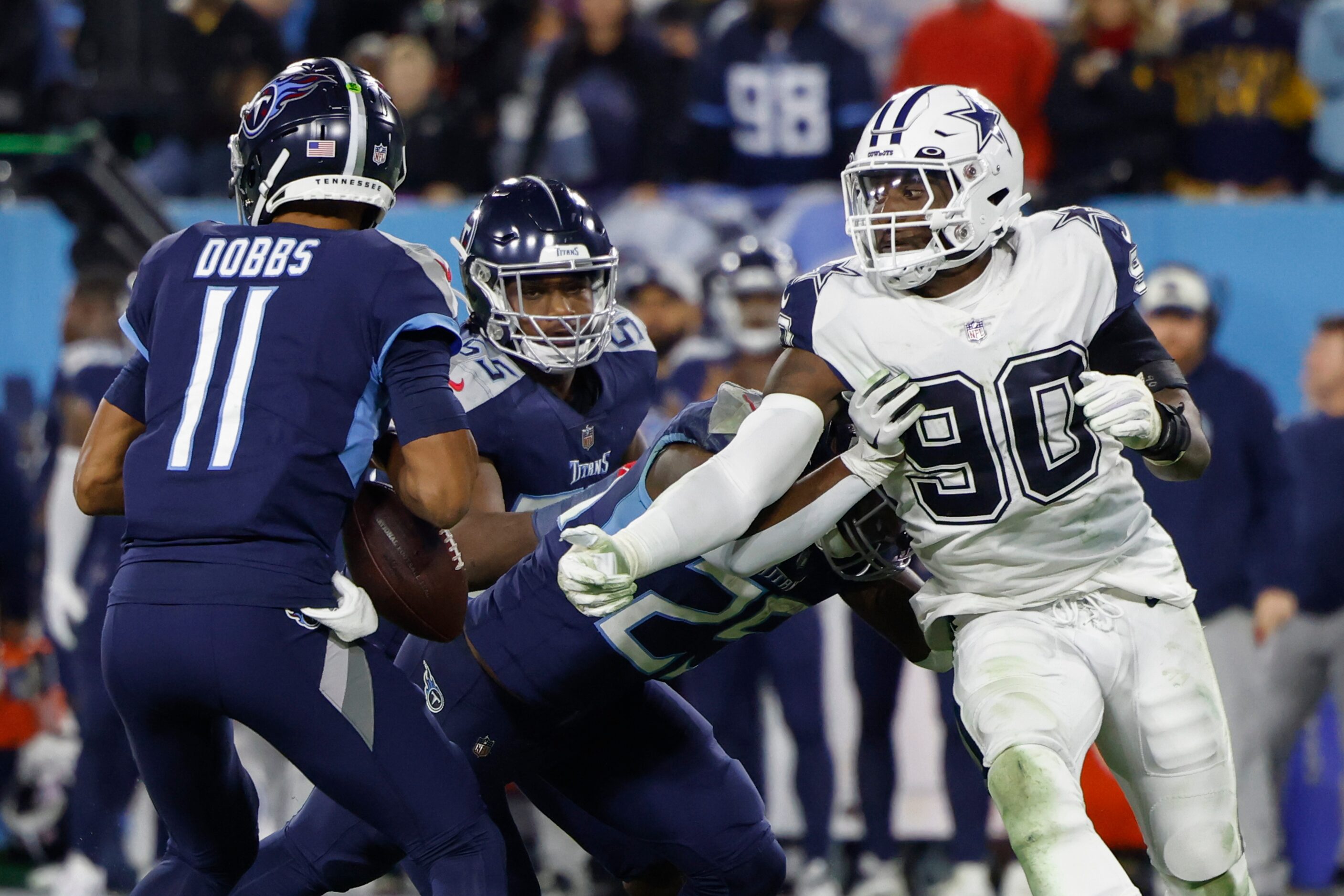 Dallas Cowboys defensive end DeMarcus Lawrence (90) forces a fumble from Tennessee Titans...