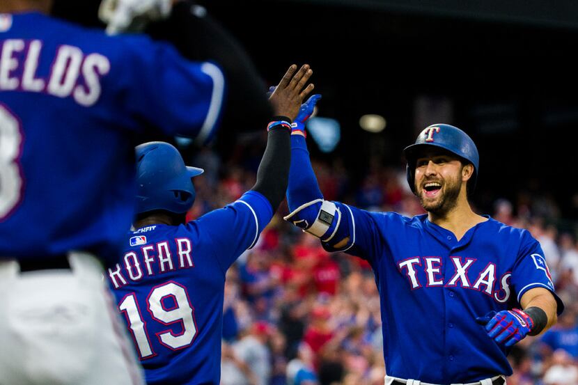 Texas Rangers third baseman Joey Gallo (13) celebrates his 2-run home run with shortstop...