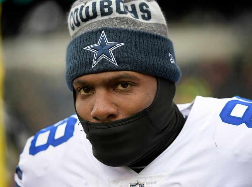 Dallas Cowboys wide receiver Dez Bryant trying to stay warm on the sidelines against the...