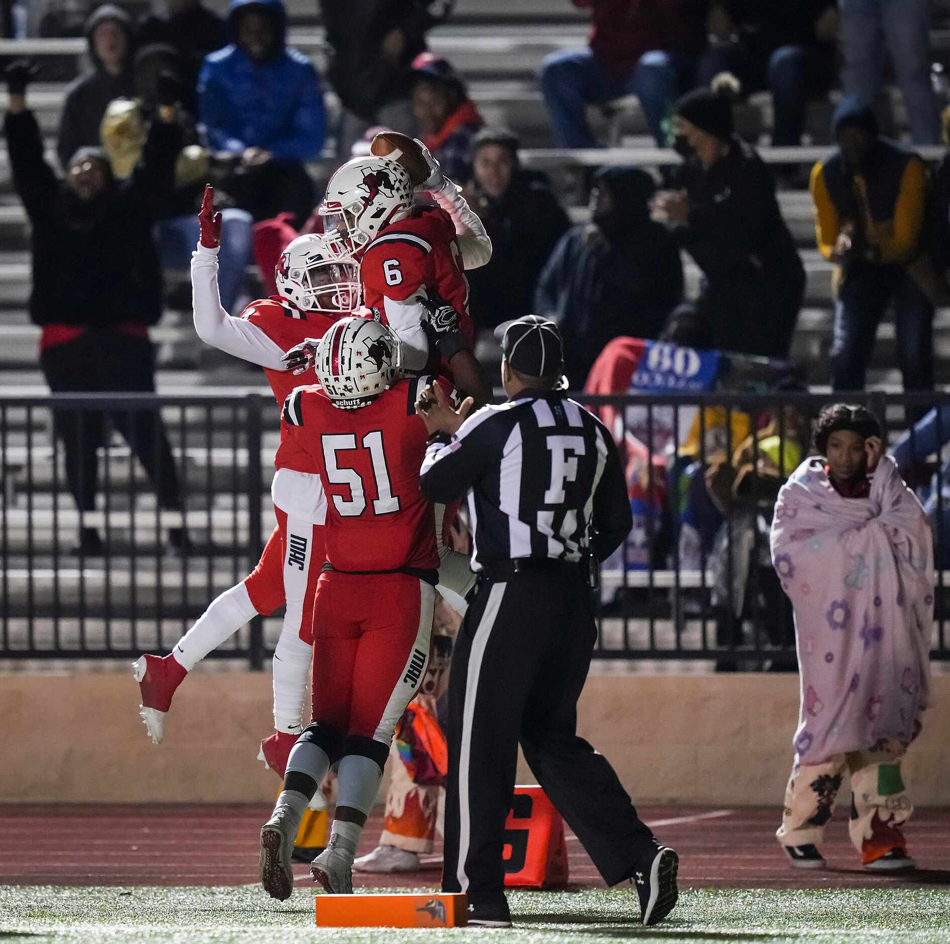 Irving MacArthur’s Tyler Littleton (6) celebrates with teammates after a score during the...